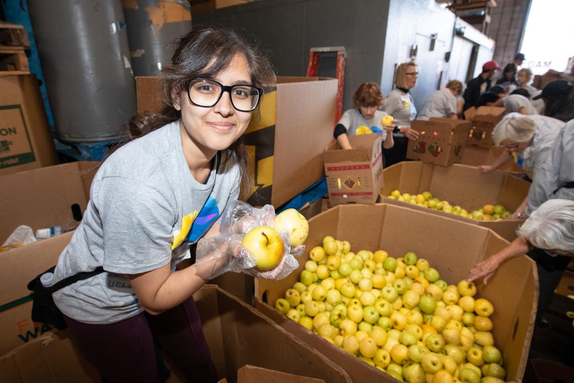 This is a photo of a UCLA volunteer at Westside Food Bank.