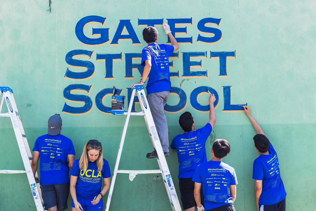 This is a photo of UCLA volunteers painting a school.
