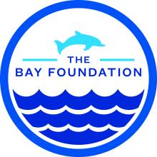 The Bay Foundation Circular Logo with an Ocean and a Dolphin 