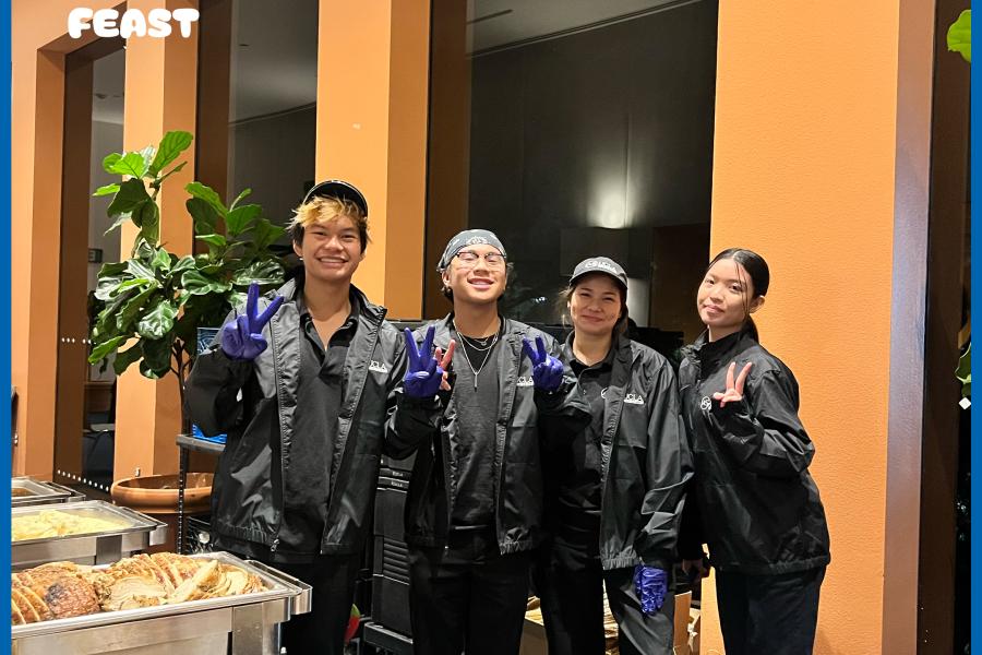 four food servers posing for a group photo at last years's fall harvest feast